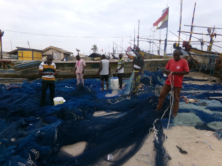 Fishermen mending their nets during the closed season in Akplabanya