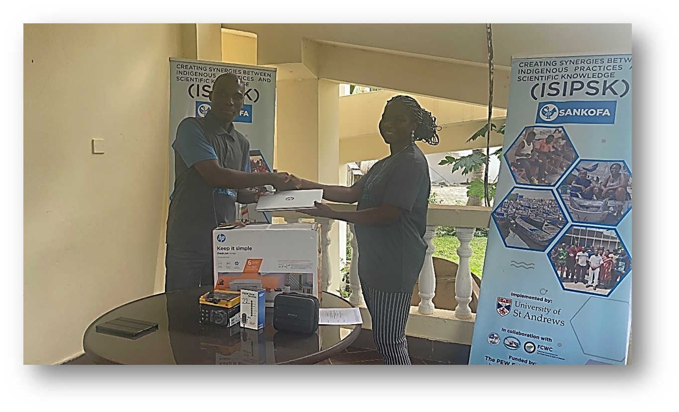 The research lead, Dr Okafor-Yarwood (positioned on the right), handing over equipment in a handshake to the President of CaFGOAG, Nana Kweigyah (positioned on the left).